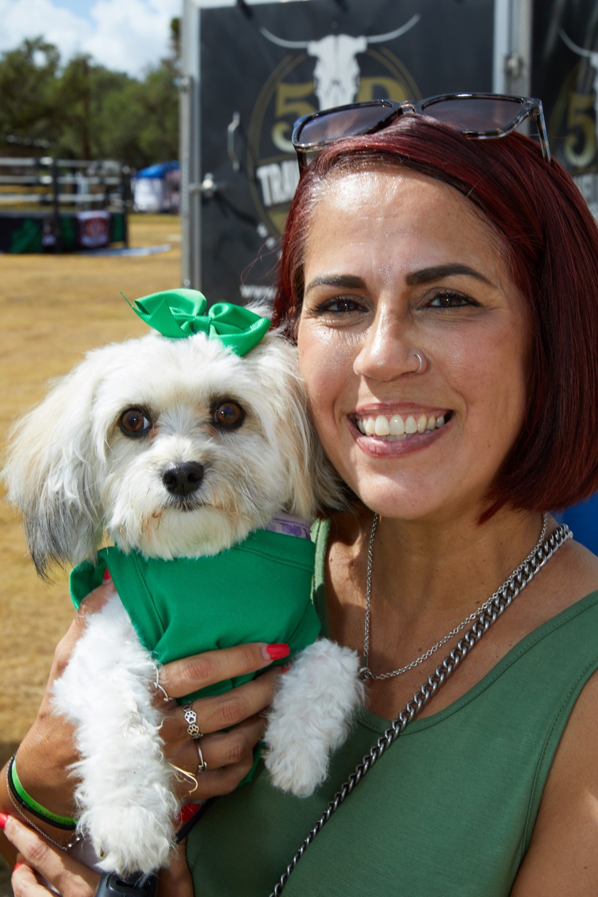 A guest holding her dressed-up dog at the festival