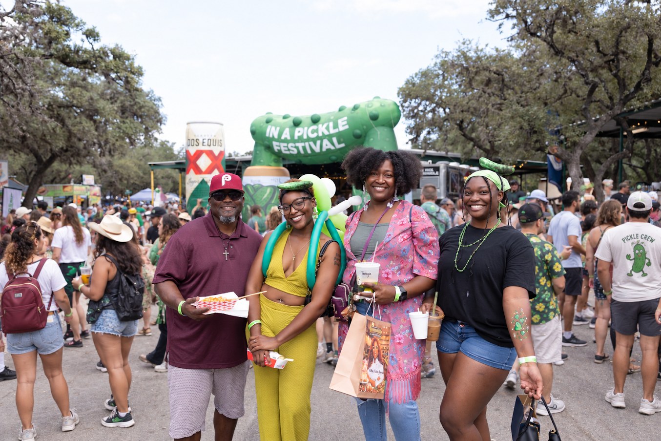 Guests posing at the giant pickle entrance
