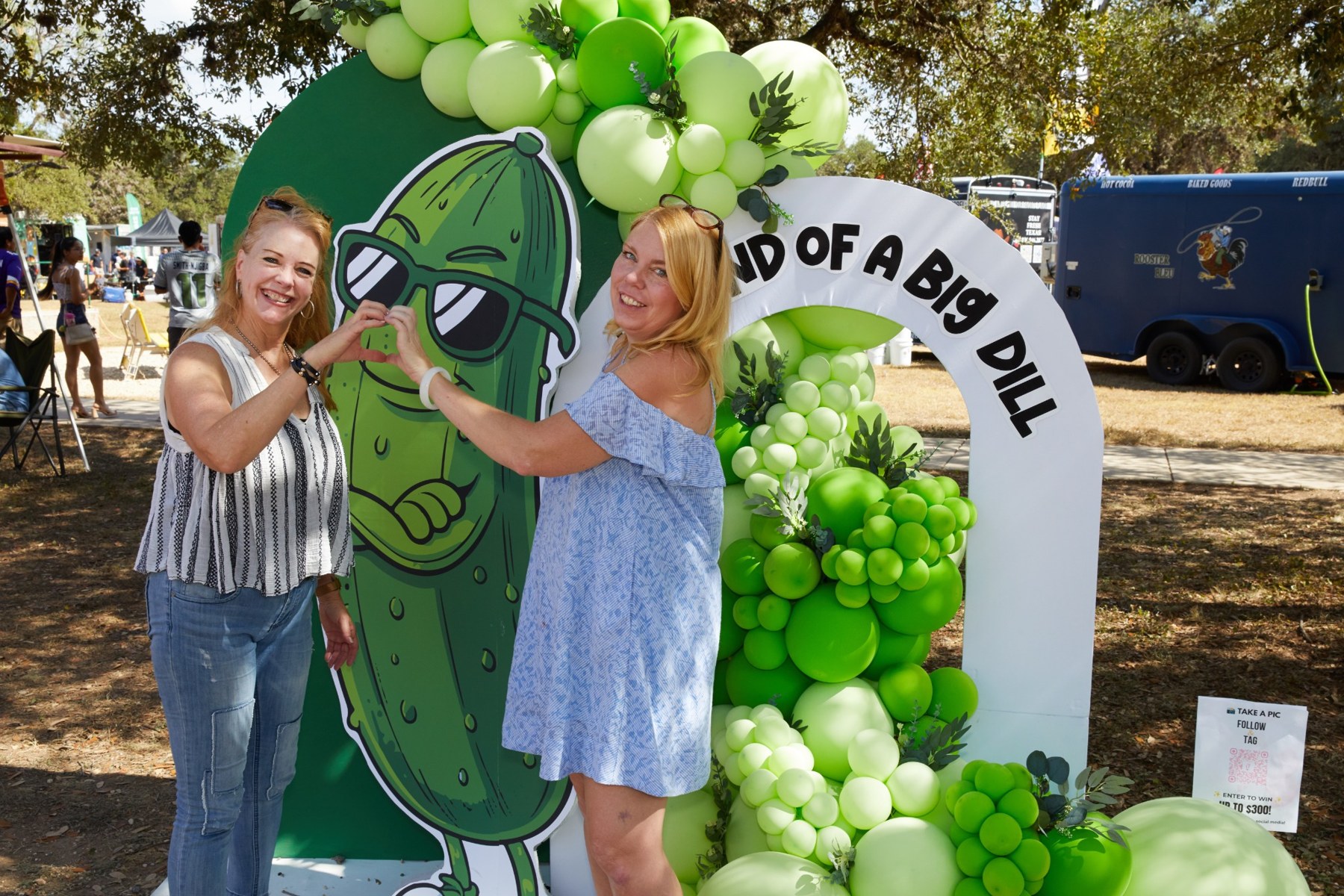 Guests posing with a pickle cutout